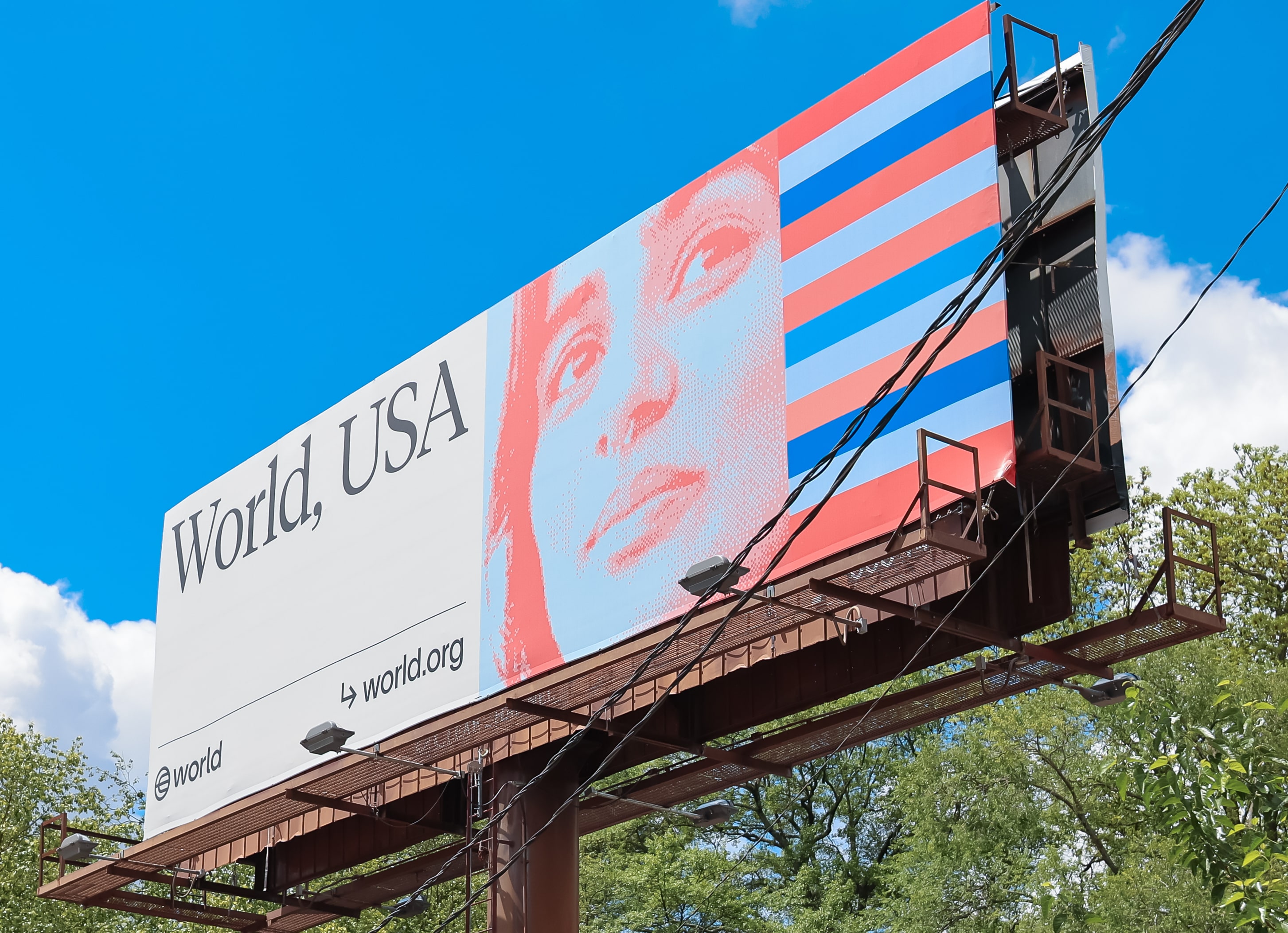 Billboard featuring the word 'World, USA' along with a stylized portrait of a woman and red and blue stripes, promoting World’s presence in Atlanta.