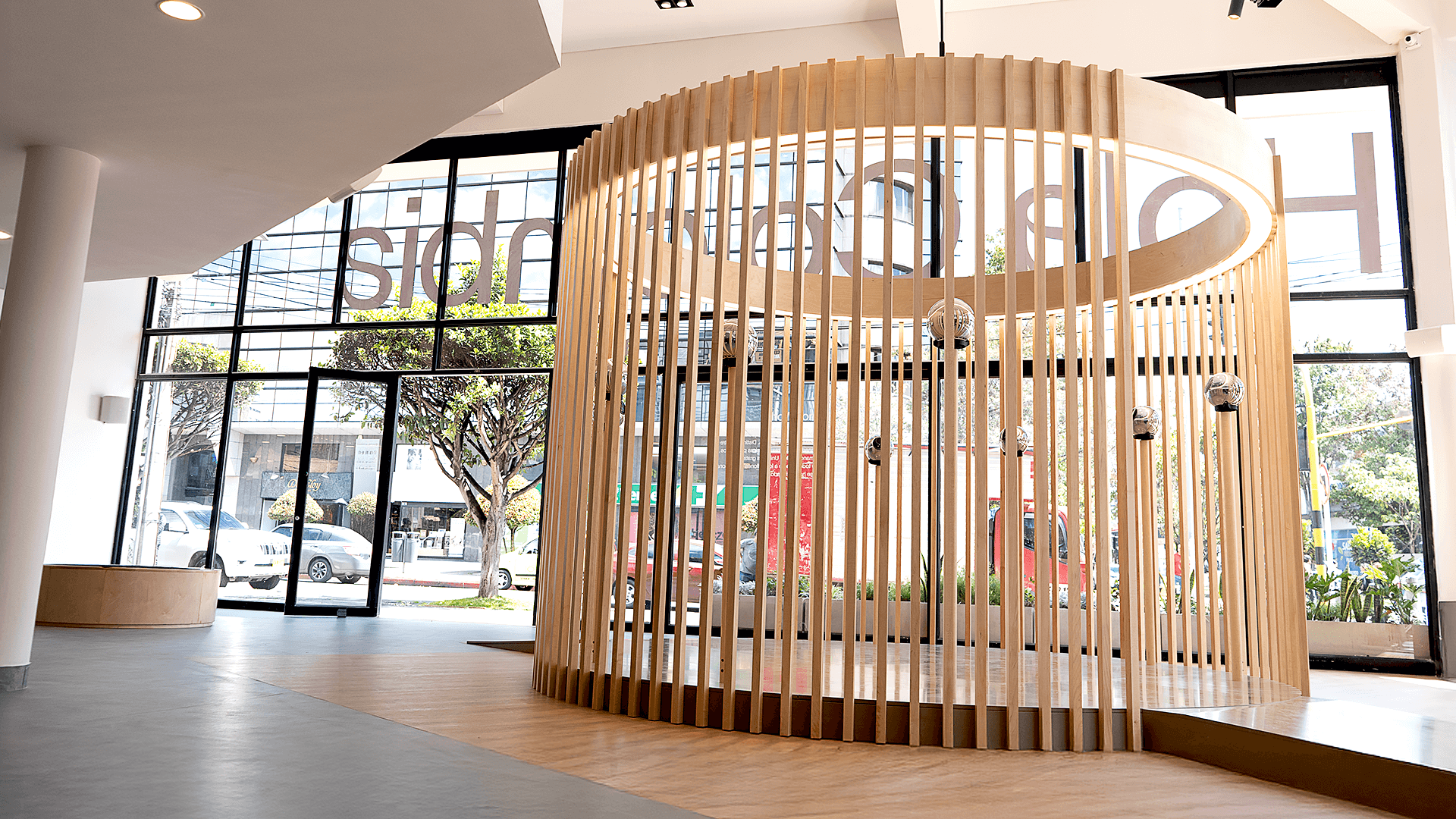 Interior view of World Space in Colombia featuring a wooden structure with vertical slats, large windows, and a spacious layout.