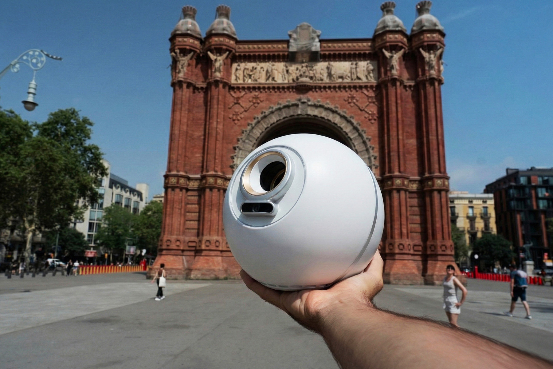 A person holds the Orb in front of the Arc de Triomf in Barcelona, symbolizing World ID access expansion in Spain.