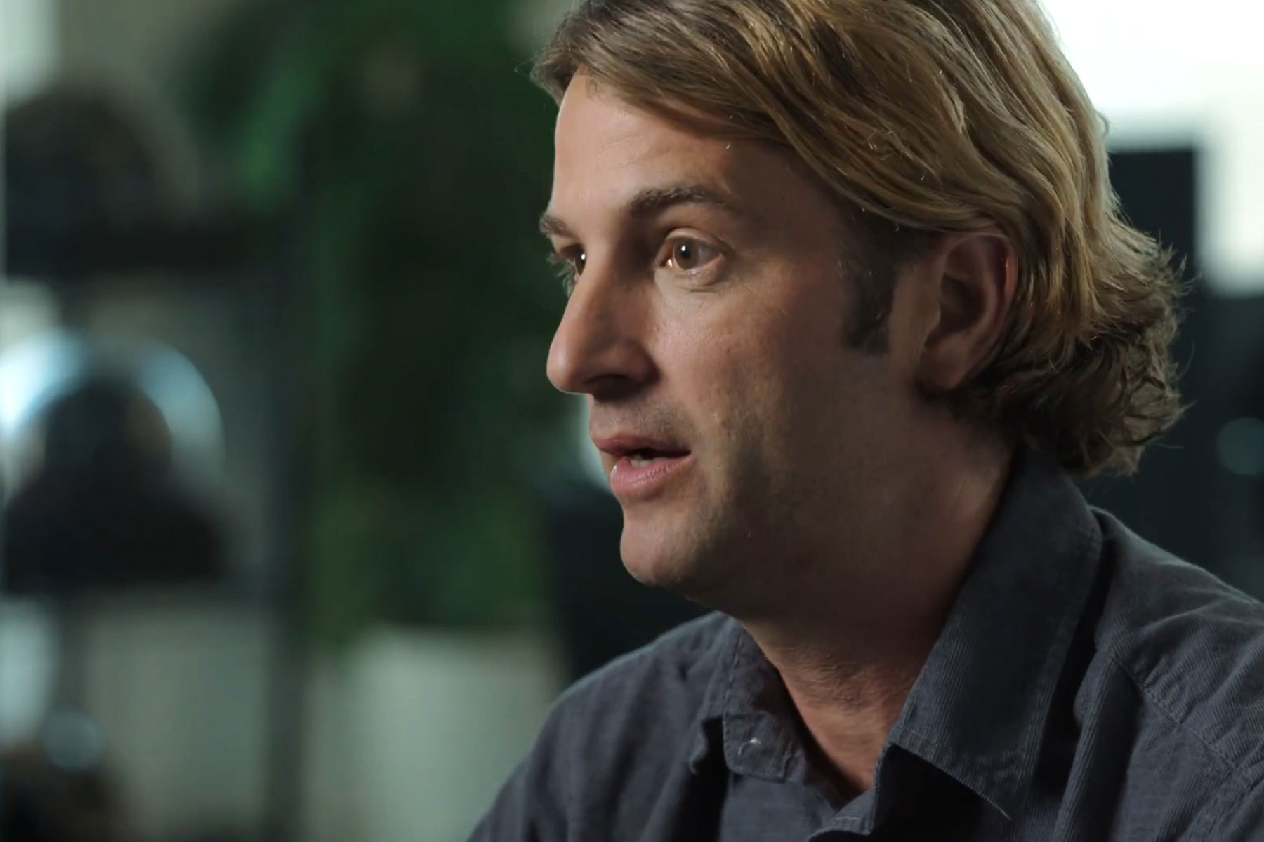 A person engaged in conversation, highlighting the importance of trust in combating deepfakes.